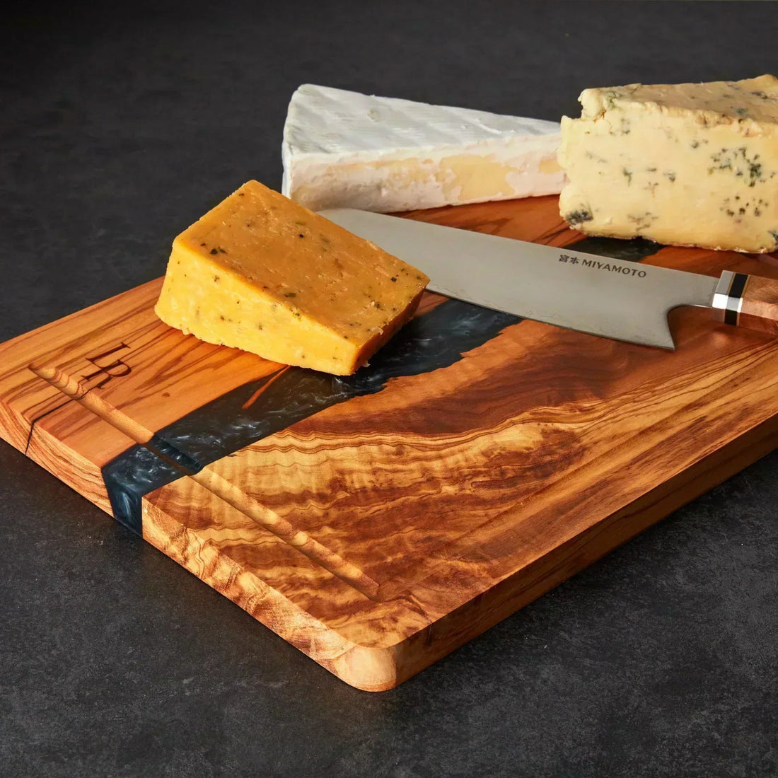 Olive wood cutting board used for kitchen preparation